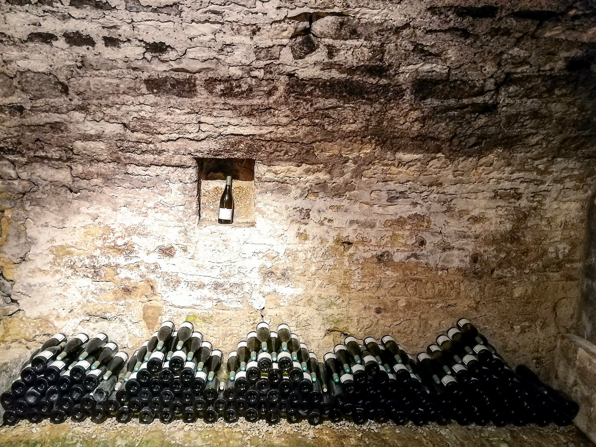 Stacked bottles in a French wine cellar