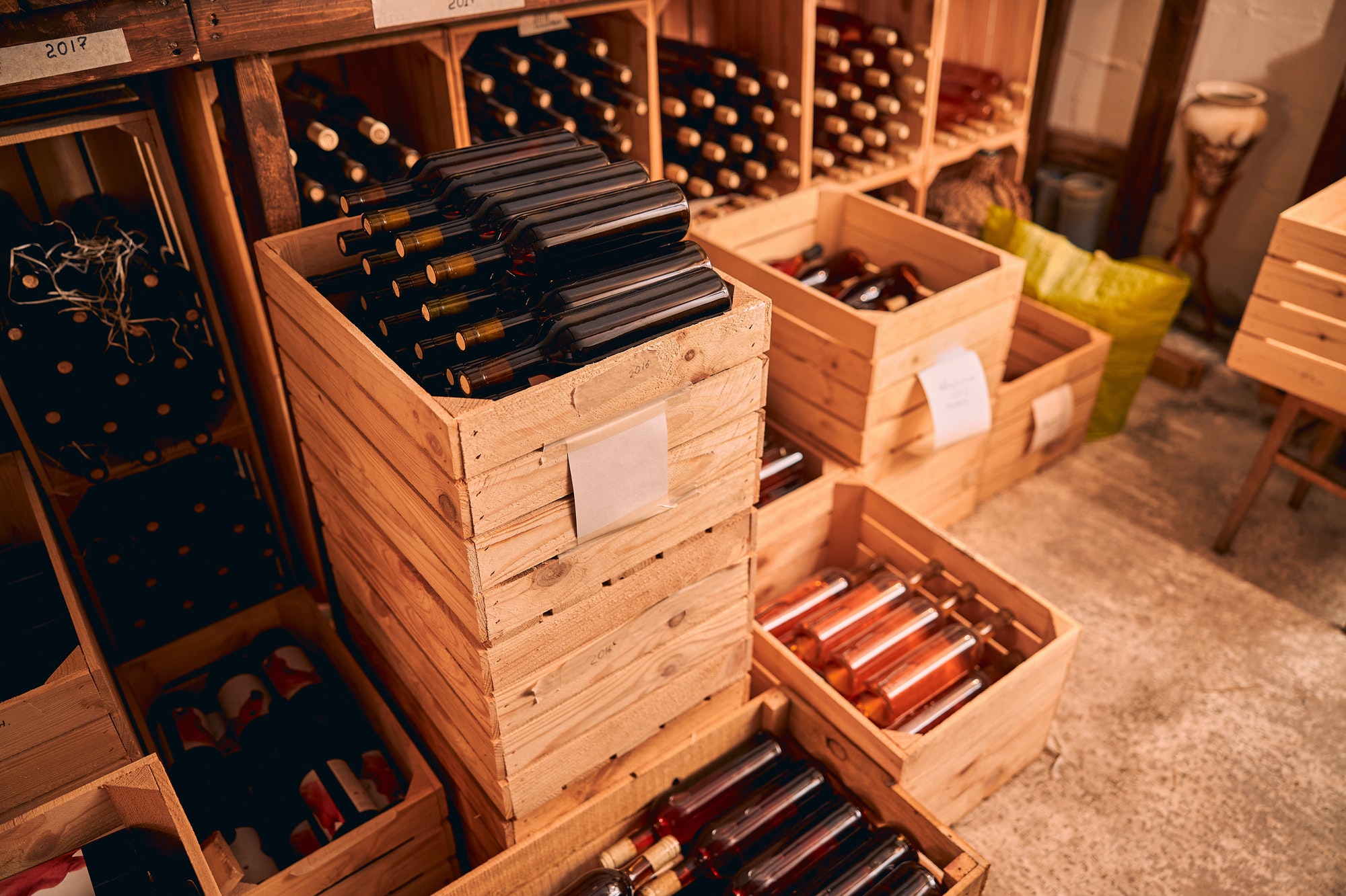 Wooden crates with wine bottles in storage room